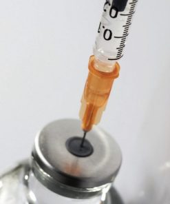 Insulin syringe puncturing a vial of compounded semaglutide for dose administration