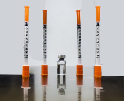 Vial of compounder tirzepatide, the active ingredient of Zepbound or Mounjaro, accompanied by four insulin syringes for administration